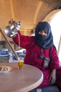 Berber woman serving Moroccan mint tea in the Sahara Desert of Merzouga