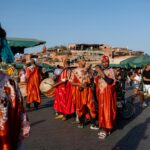 People in traditional colorful clothing walking through a Marrakech street